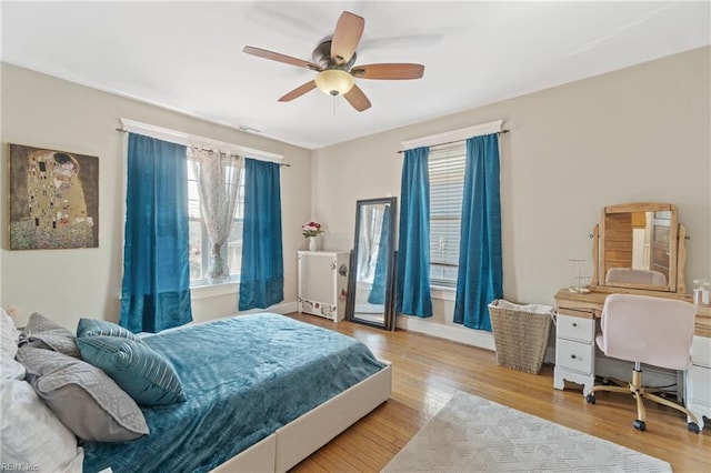 bedroom with a ceiling fan and wood finished floors