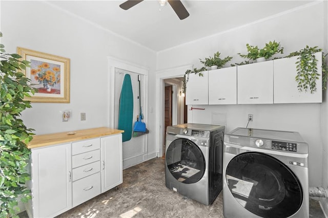 laundry room with a ceiling fan, cabinet space, and separate washer and dryer