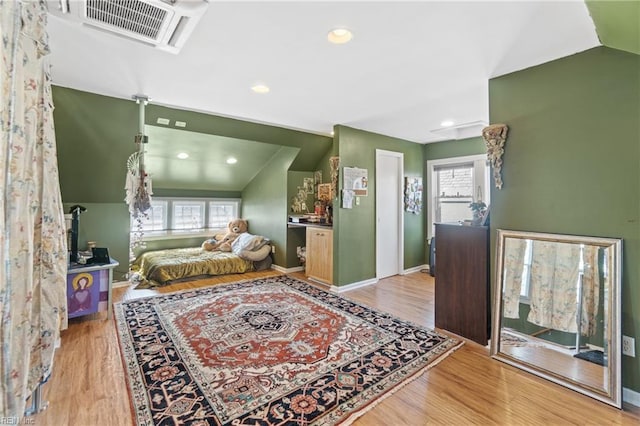 bedroom with recessed lighting, visible vents, baseboards, vaulted ceiling, and light wood-type flooring