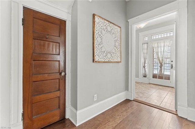 entryway with wood finished floors and baseboards