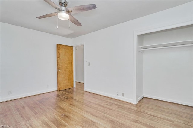 unfurnished bedroom featuring a closet, wood finished floors, a ceiling fan, and baseboards