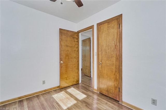 unfurnished room featuring a ceiling fan, baseboards, and wood finished floors