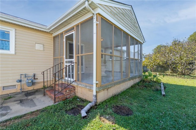 exterior space featuring a yard, crawl space, and a sunroom