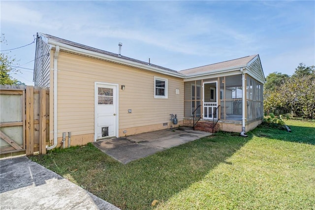 back of property with fence, a sunroom, a yard, crawl space, and a patio area