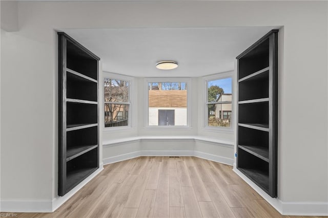 interior space with light wood-type flooring and baseboards