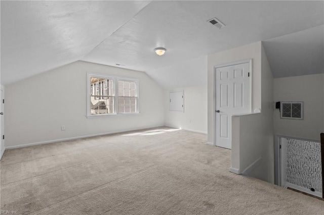 bonus room with lofted ceiling, baseboards, visible vents, and carpet