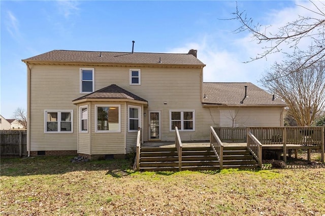 back of property with a yard, a chimney, crawl space, fence, and a deck