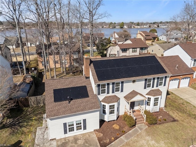 bird's eye view featuring a water view and a residential view