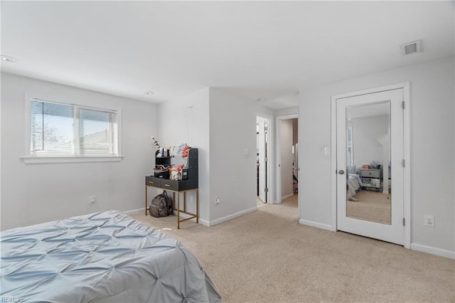 carpeted bedroom featuring visible vents and baseboards