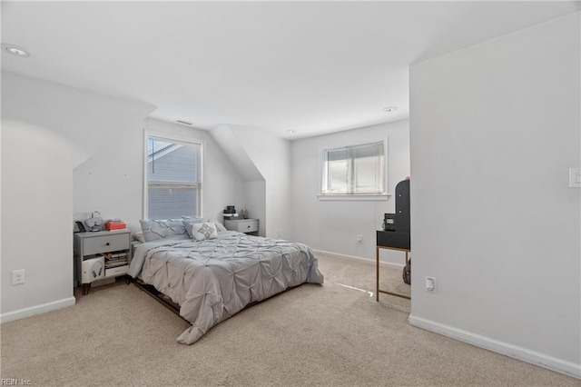 bedroom with carpet, baseboards, and vaulted ceiling