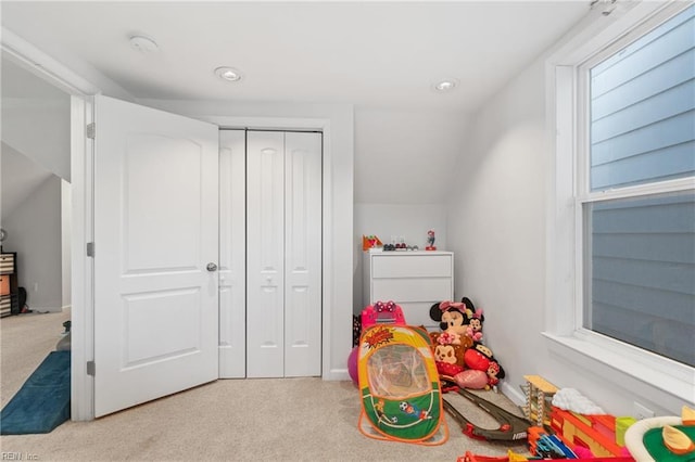 game room featuring lofted ceiling and light colored carpet