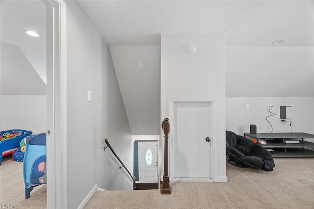 interior space featuring lofted ceiling and carpet