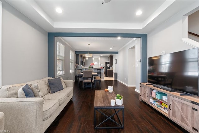 living room featuring dark wood-type flooring, recessed lighting, and baseboards