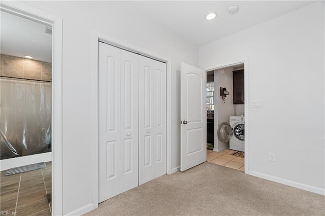 carpeted bedroom with baseboards, washer / clothes dryer, tile patterned flooring, a closet, and recessed lighting