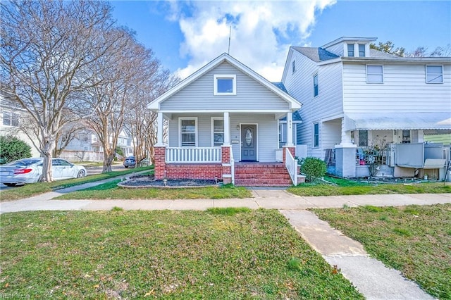 view of front facade with a porch and a front lawn