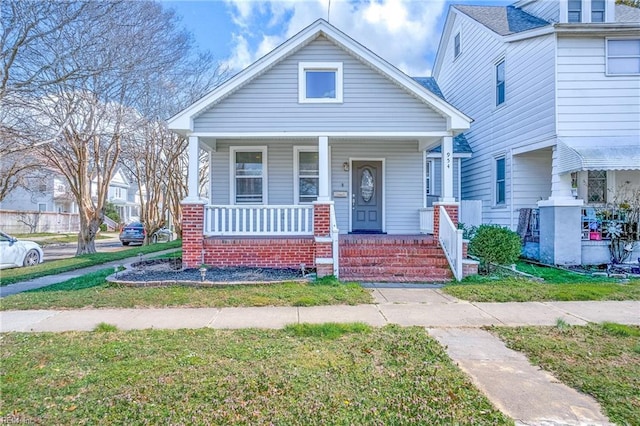 view of front of home featuring a porch and a front lawn