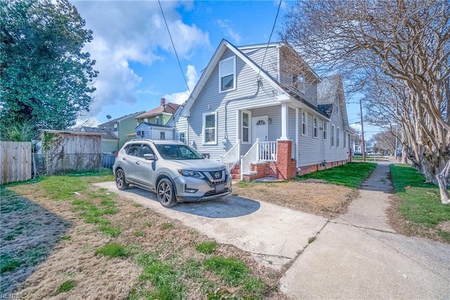 view of side of home featuring fence and driveway