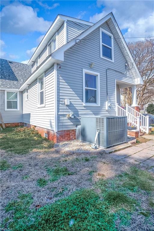 view of property exterior featuring crawl space, covered porch, and central AC