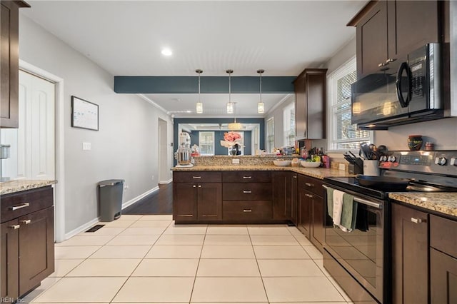 kitchen featuring light tile patterned flooring, dark brown cabinetry, a peninsula, and black appliances