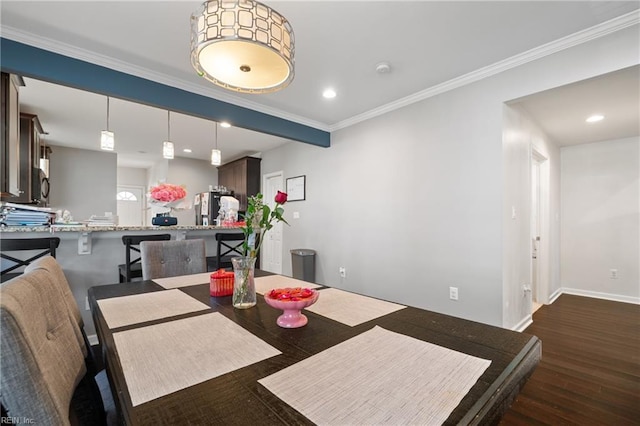 dining area with recessed lighting, crown molding, baseboards, and wood finished floors