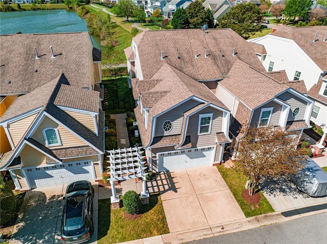 drone / aerial view featuring a water view and a residential view