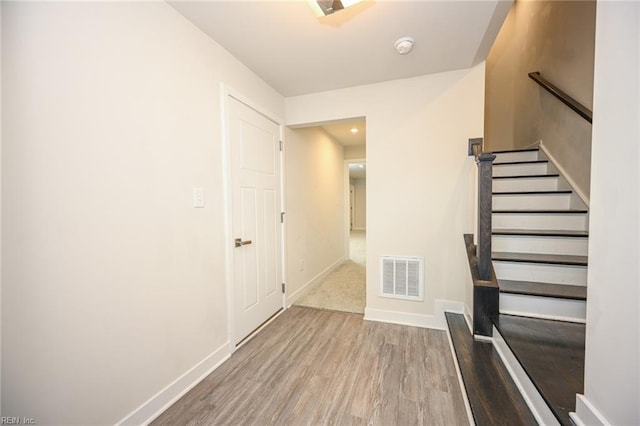 interior space featuring wood finished floors, visible vents, and baseboards