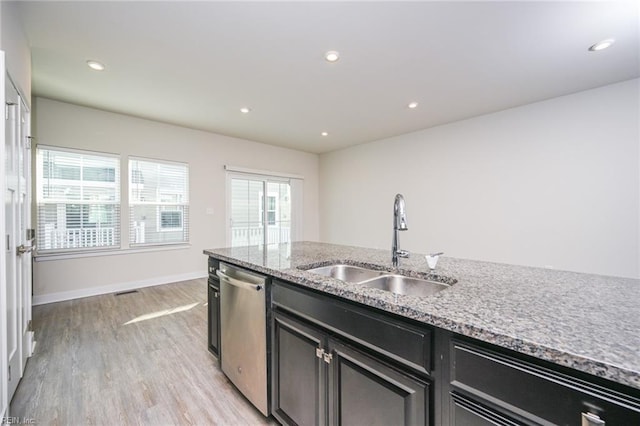 kitchen with a sink, light wood-style floors, stainless steel dishwasher, and recessed lighting