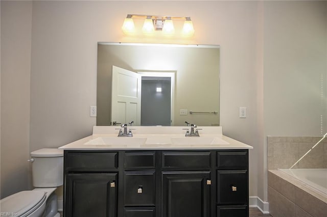 full bath with a relaxing tiled tub, a sink, toilet, and double vanity