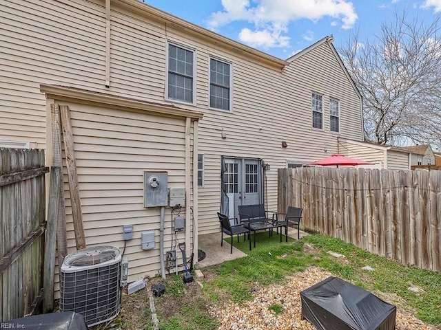 back of property featuring fence, a patio, and central AC unit