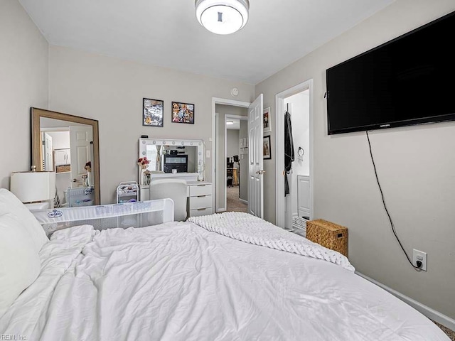 carpeted bedroom with ensuite bath