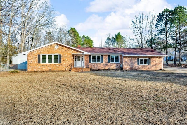 ranch-style house featuring brick siding, a chimney, a front yard, and fence