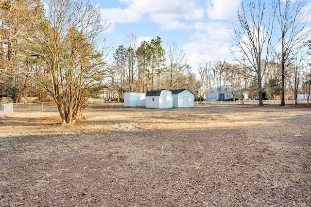 view of yard featuring an outbuilding and fence