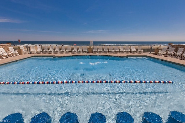 community pool featuring a patio and a water view