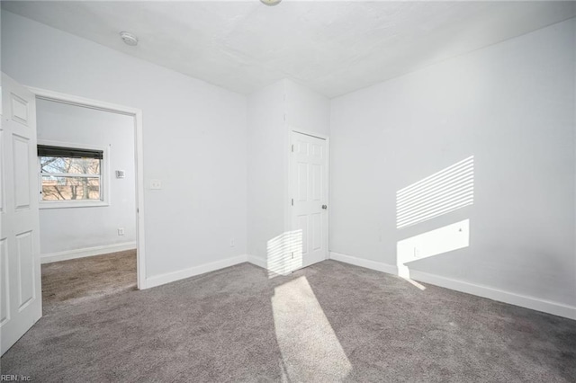 unfurnished bedroom featuring carpet and baseboards