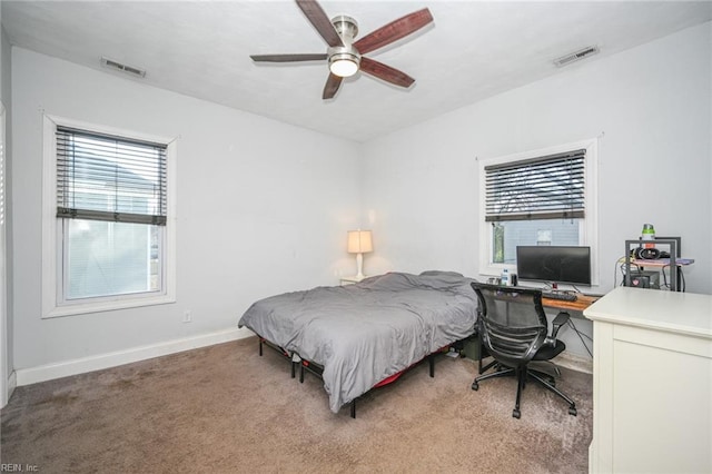 bedroom featuring baseboards, a ceiling fan, visible vents, and light colored carpet