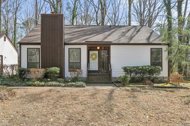 mid-century modern home with a chimney