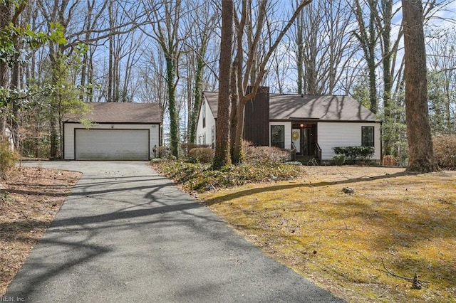 mid-century home with an outbuilding and driveway