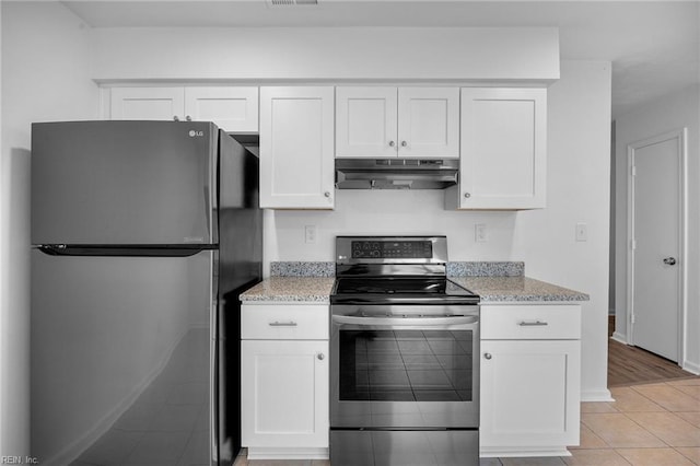 kitchen featuring stainless steel appliances, white cabinetry, under cabinet range hood, and light stone countertops