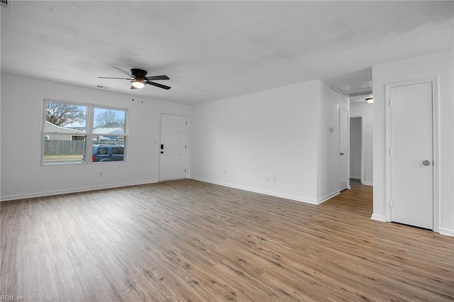 spare room featuring ceiling fan, wood finished floors, and baseboards