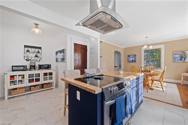 kitchen with arched walkways, blue cabinets, stainless steel appliances, marble finish floor, and wooden counters