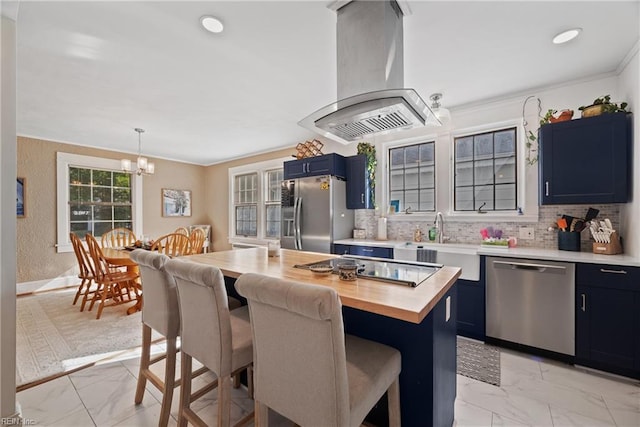 kitchen featuring island range hood, appliances with stainless steel finishes, a breakfast bar, blue cabinets, and marble finish floor