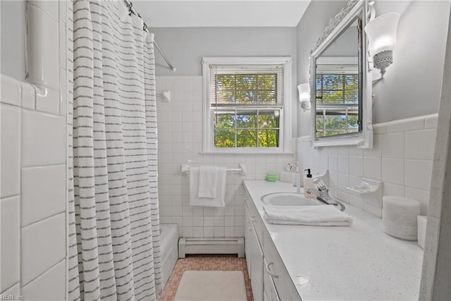 bathroom with shower / bath combination with curtain, baseboard heating, vanity, and tile walls