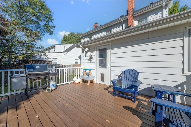 wooden terrace featuring fence and grilling area