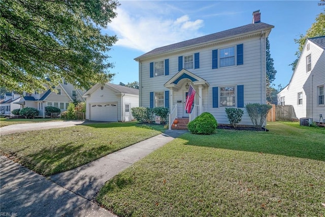 colonial home with a garage, central AC, fence, a chimney, and a front yard