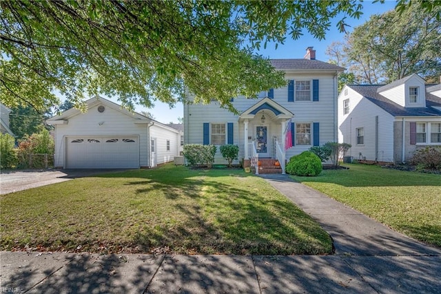 colonial home featuring a chimney, concrete driveway, and a front yard