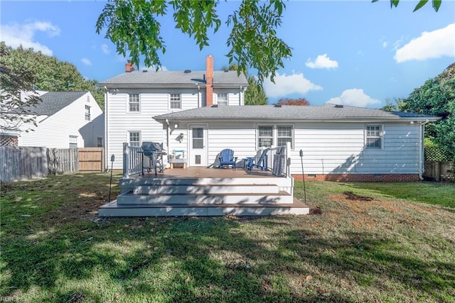 rear view of house featuring crawl space, a fenced backyard, a lawn, and a wooden deck