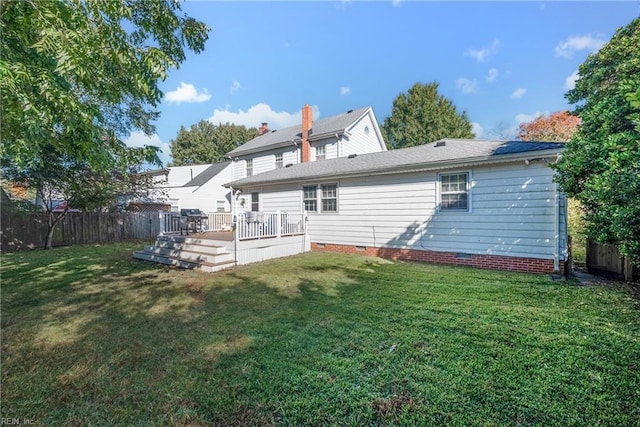 back of house with crawl space, fence, a lawn, and a wooden deck