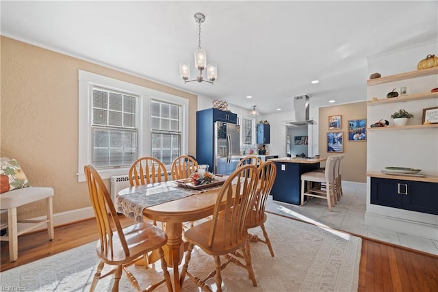 dining space featuring a chandelier, recessed lighting, baseboards, and light wood finished floors