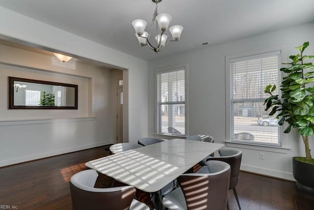 dining area with dark wood-type flooring, a wealth of natural light, and baseboards