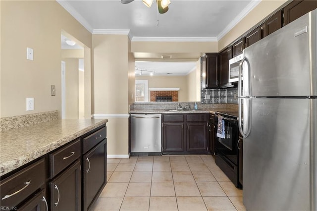 kitchen featuring dark brown cabinetry, light tile patterned floors, tasteful backsplash, appliances with stainless steel finishes, and ornamental molding